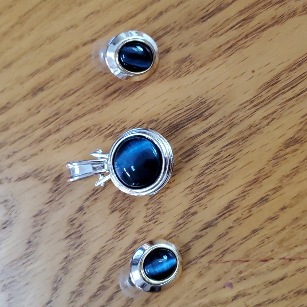 Blue pendant with matching pierced earrings.  Pendant is 1 3/4 x 3/4. Silver.